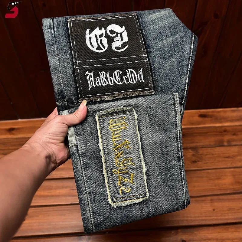 High-End Jeans Pánská podzimní a zimní móda roztrhaná nášivka Pu Shuai vyšívané Slim Fit úzké strečové kalhoty s potiskem