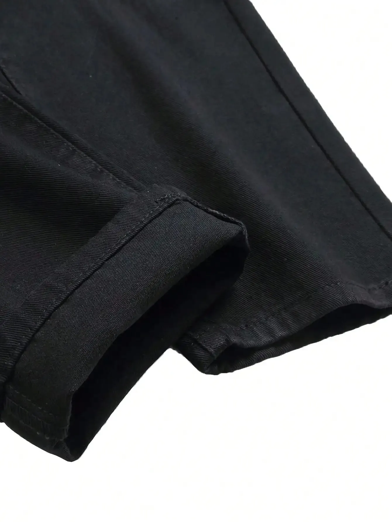 Single piece of trendy streetwear: straight-cut ripped denim jeans in black.