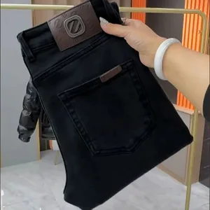 Nueva moda Harajuku para hombre, ropa de lujo de estilo coreano para primavera y otoño, pantalones vaqueros ajustados para hombre, pantalones negros informales, pantalones de algodón
